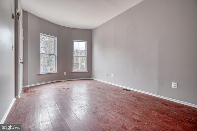 spare room featuring wood-type flooring