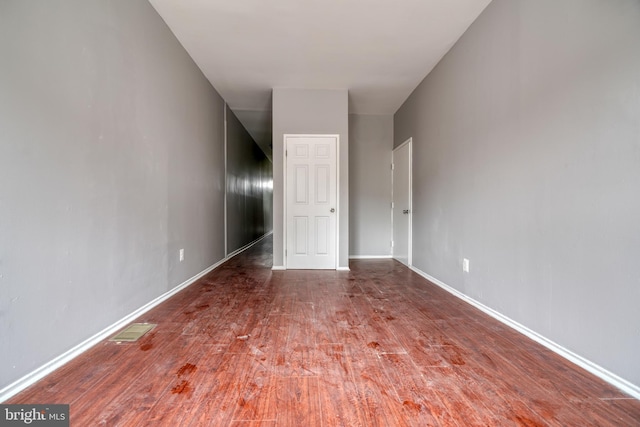 spare room featuring dark wood-type flooring