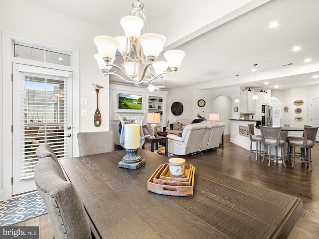 dining area with a chandelier and dark wood-type flooring