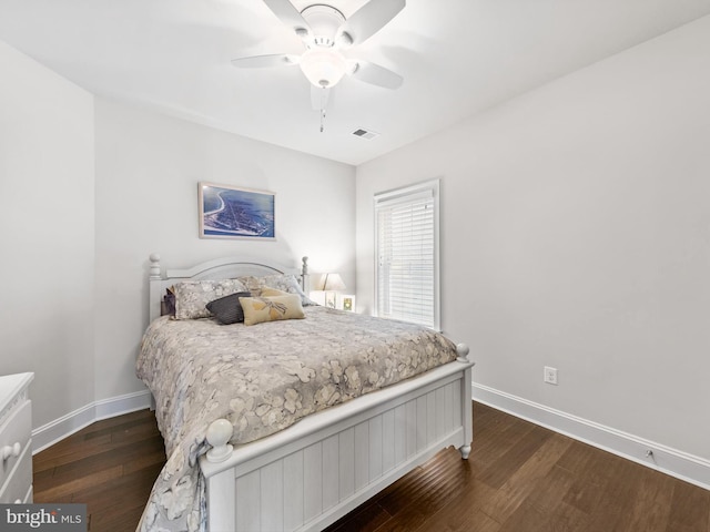 bedroom with ceiling fan and dark hardwood / wood-style flooring