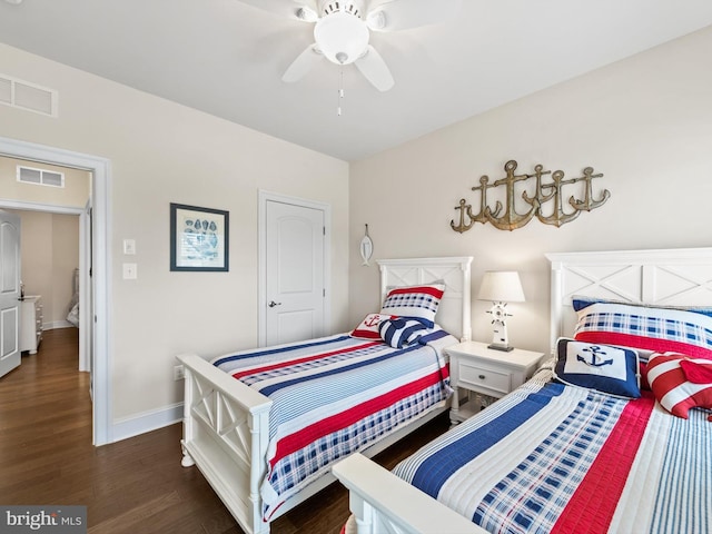 bedroom with ceiling fan and dark wood-type flooring