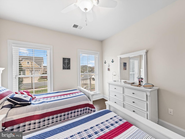 bedroom with ceiling fan and dark wood-type flooring