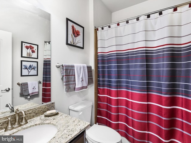 bathroom featuring toilet and vanity