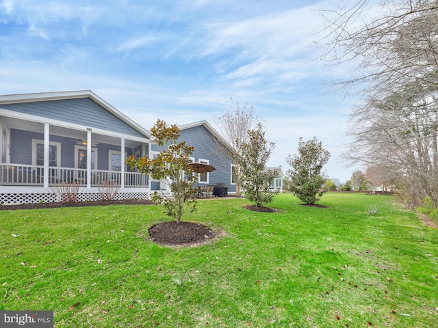 view of yard featuring a sunroom