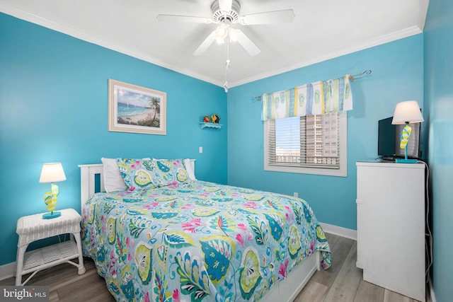 bedroom featuring crown molding, ceiling fan, and light wood-type flooring