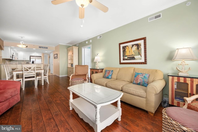 living room with ceiling fan, dark wood-type flooring, and crown molding