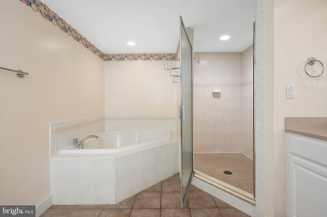 bathroom featuring independent shower and bath, vanity, and tile flooring