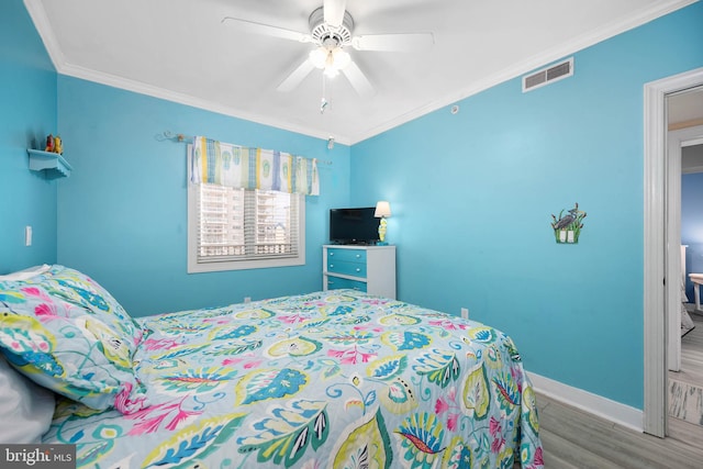 bedroom with dark hardwood / wood-style flooring, ceiling fan, and crown molding