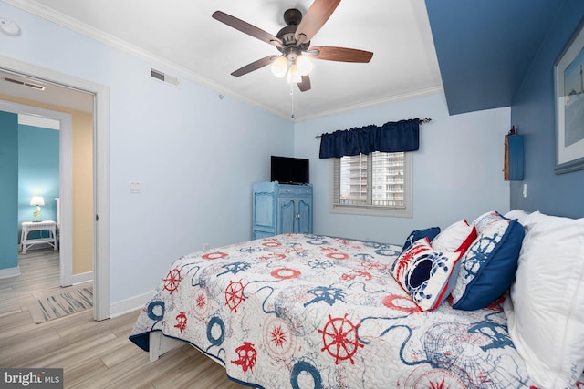 bedroom featuring ornamental molding, ceiling fan, and light wood-type flooring