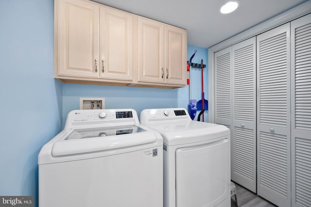 laundry room with cabinets, hookup for a washing machine, and washing machine and dryer