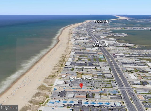 birds eye view of property featuring a water view and a view of the beach