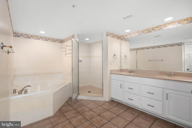 bathroom with tile floors, double vanity, and plus walk in shower