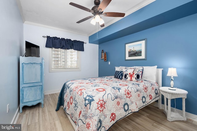 bedroom featuring ornamental molding, ceiling fan, and light wood-type flooring