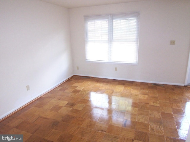 empty room with light parquet flooring