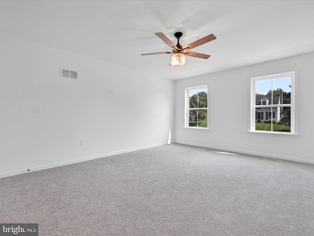 empty room featuring carpet flooring and ceiling fan