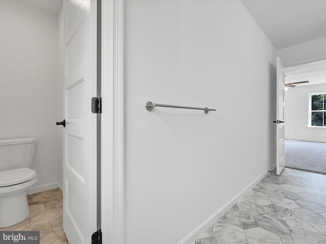 bathroom featuring tile floors, ceiling fan, and toilet