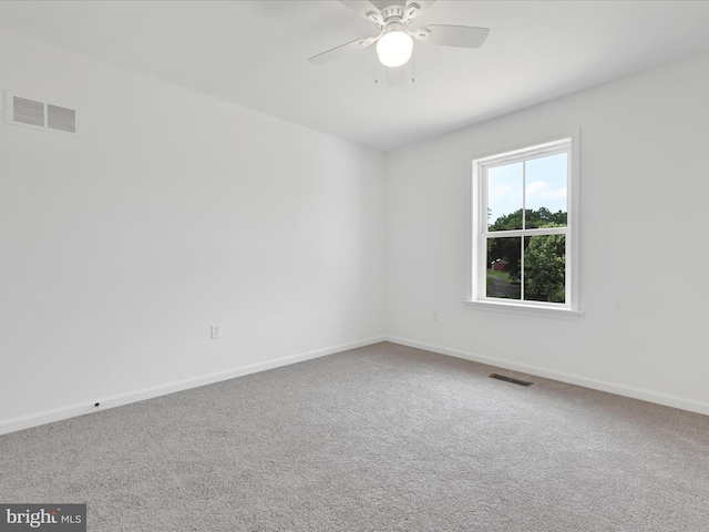 unfurnished room featuring ceiling fan and carpet