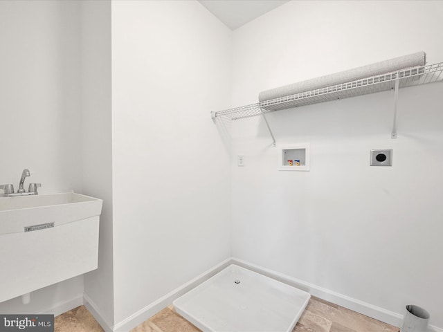 laundry area with electric dryer hookup, sink, light tile floors, and hookup for a washing machine