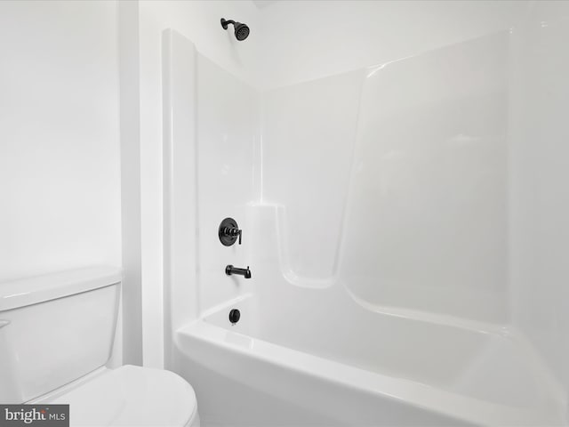 bathroom with shower / washtub combination and toilet