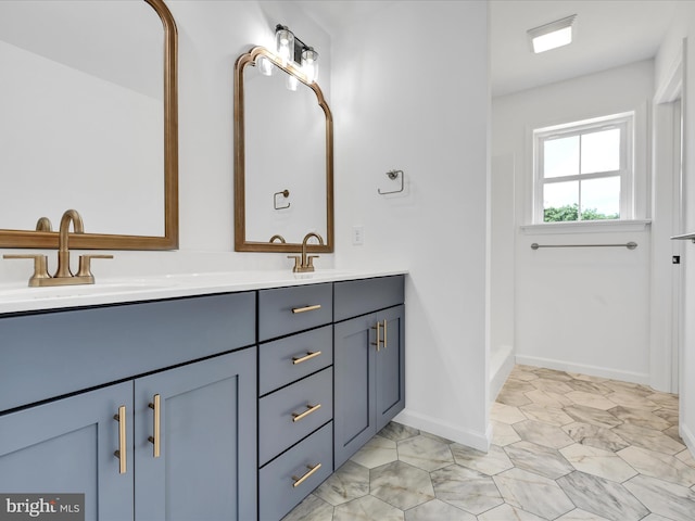 bathroom with dual bowl vanity and tile flooring