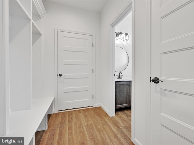 hall featuring sink and light wood-type flooring