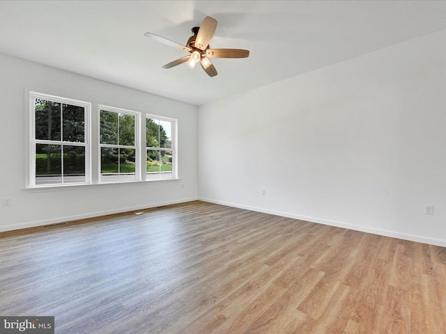 empty room featuring ceiling fan and light hardwood / wood-style flooring