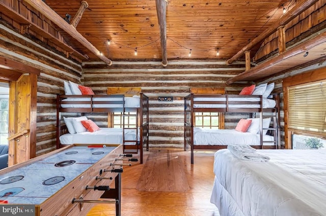 bedroom featuring log walls, wooden ceiling, beam ceiling, and light hardwood / wood-style floors