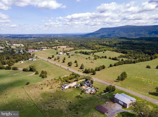 birds eye view of property with a mountain view and a rural view