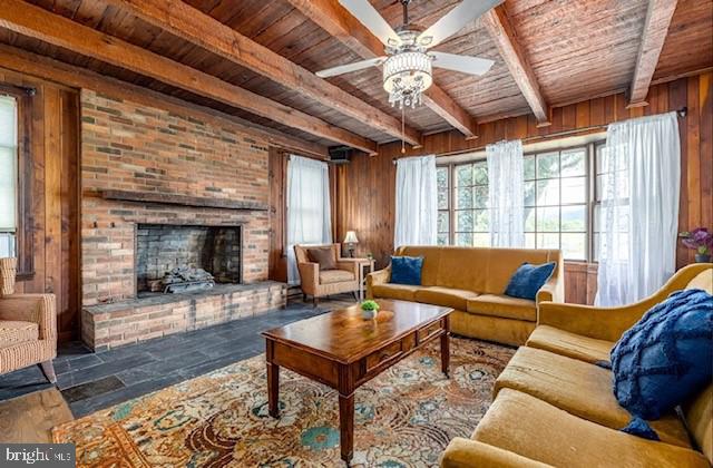 tiled living room featuring wooden walls, beam ceiling, and wood ceiling