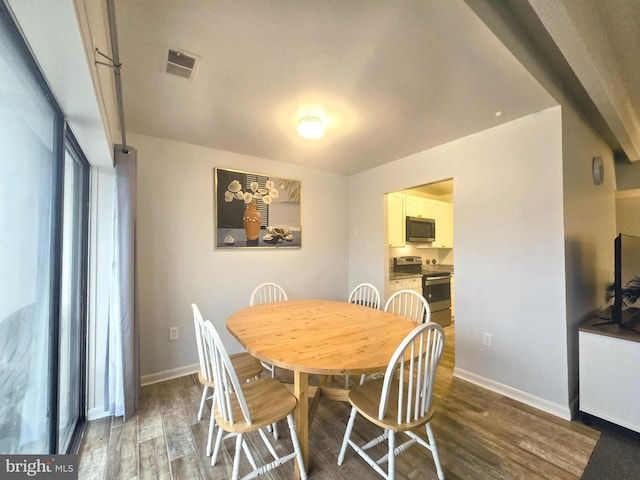 dining area with dark hardwood / wood-style floors