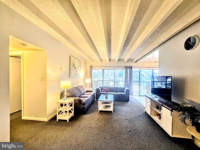 carpeted living room with beamed ceiling and a textured ceiling