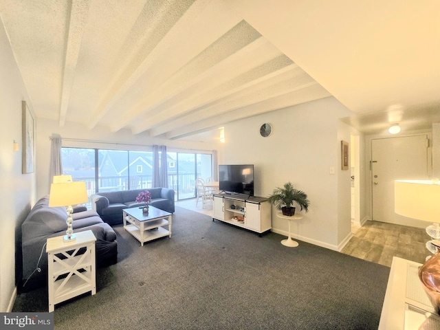 living room featuring carpet and beamed ceiling