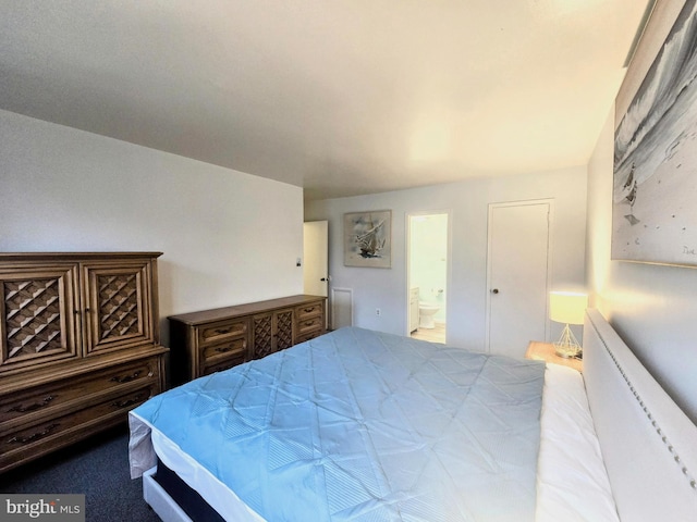 carpeted bedroom featuring ensuite bathroom