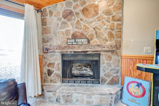 room details featuring light tile floors, wood ceiling, and a fireplace