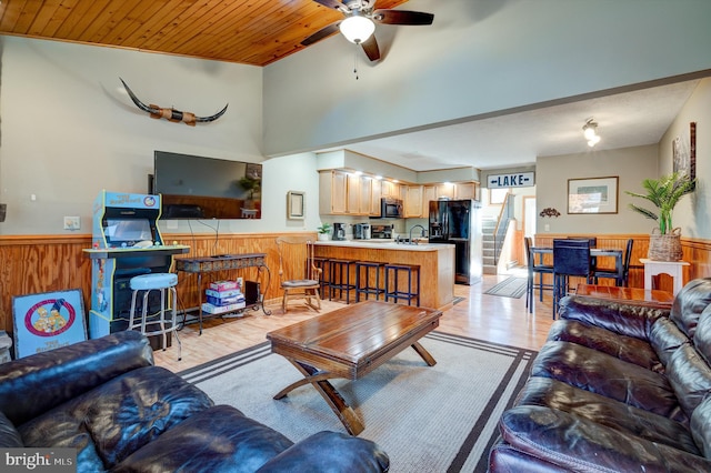 living room featuring wooden ceiling, ceiling fan, sink, and light wood-type flooring