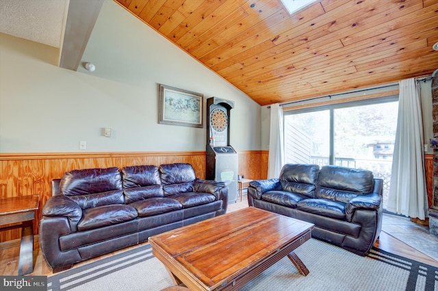 living room featuring lofted ceiling with skylight