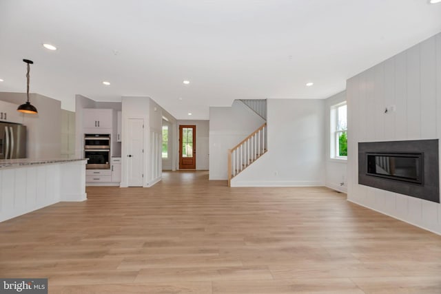 unfurnished living room featuring light hardwood / wood-style floors