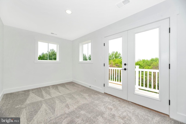 carpeted empty room with french doors