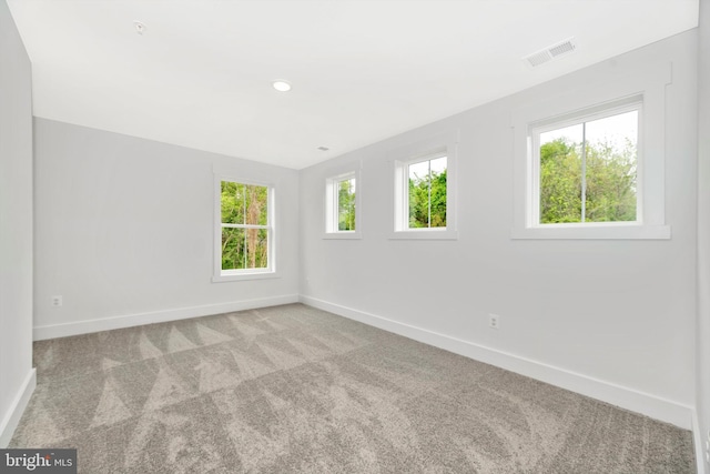 empty room featuring light colored carpet