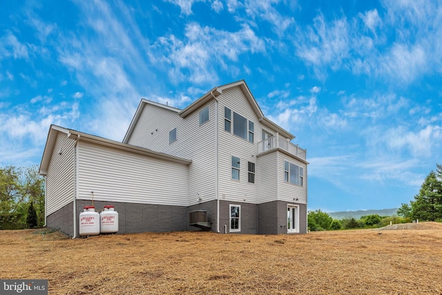 rear view of property with a yard