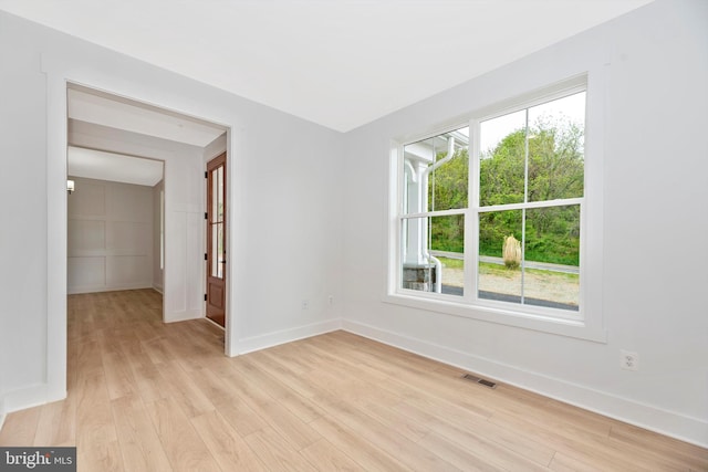 unfurnished room with light wood-type flooring