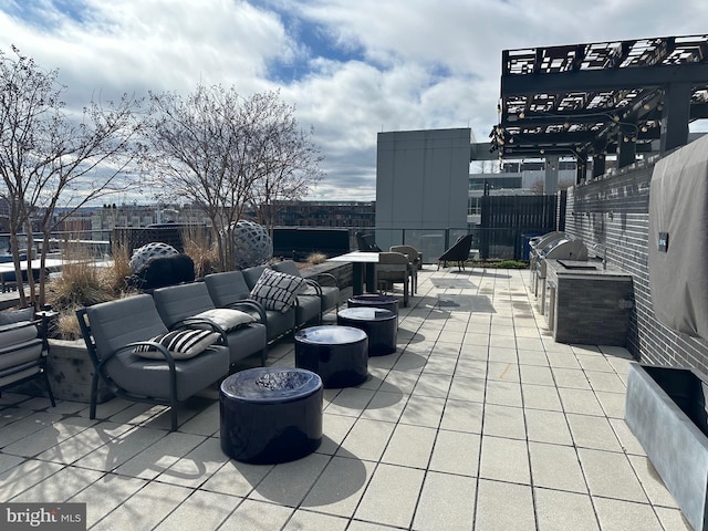 view of patio featuring area for grilling and an outdoor living space with a fire pit