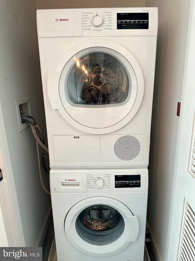 laundry area with stacked washing maching and dryer and hookup for a washing machine