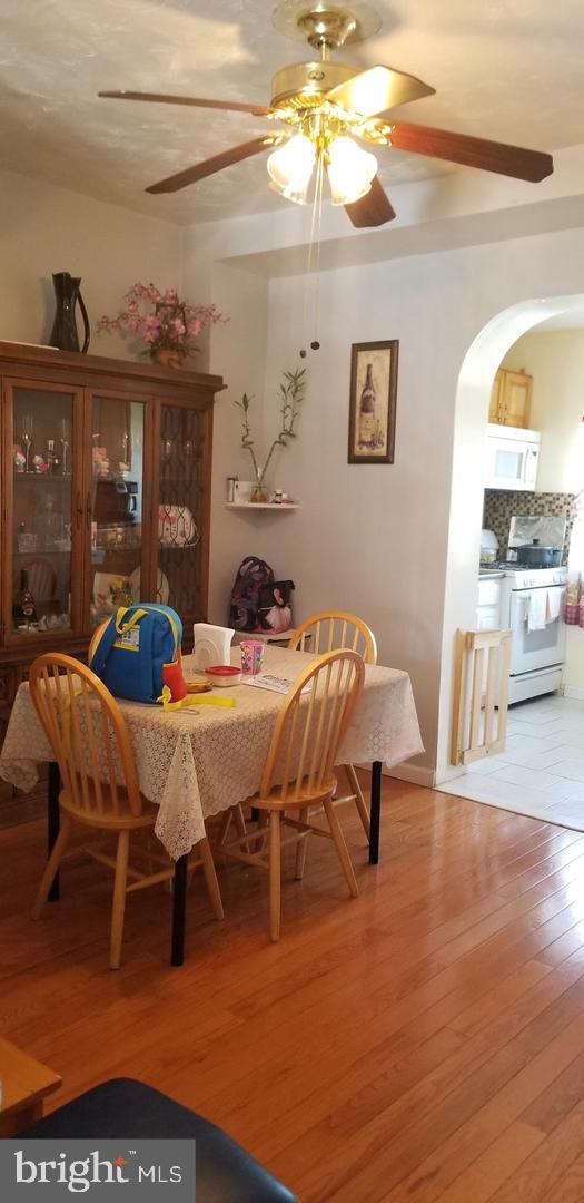 tiled dining area featuring ceiling fan