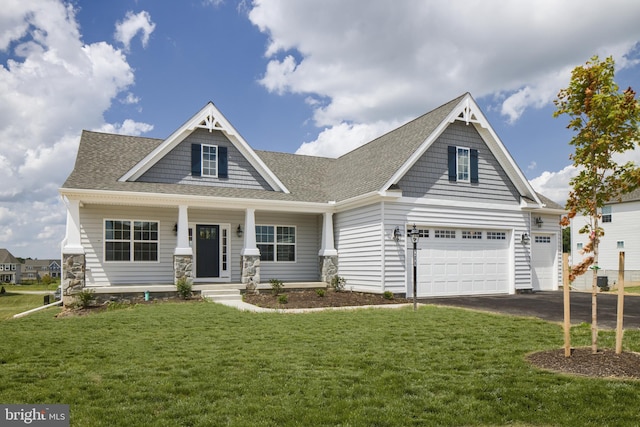 craftsman inspired home with a front lawn, a porch, and a garage