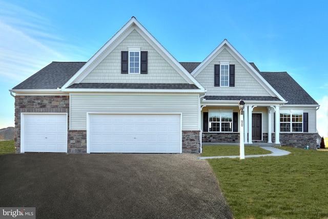 craftsman house featuring covered porch and a front lawn