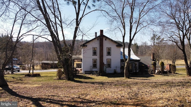 view of property exterior with a yard