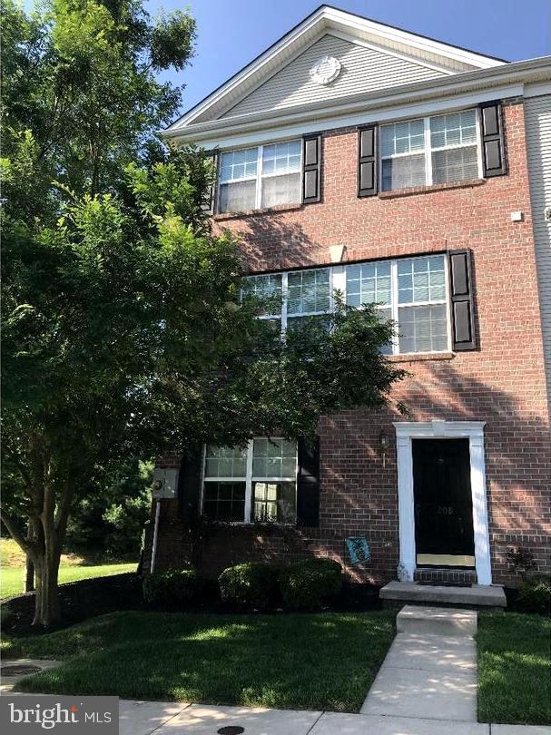 view of front of house with brick siding and a front lawn