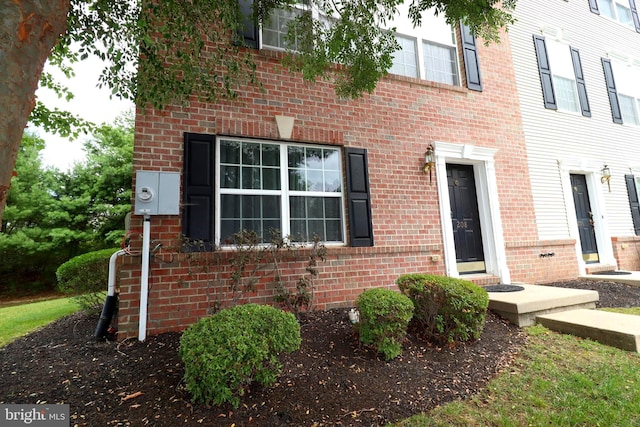 exterior space featuring brick siding