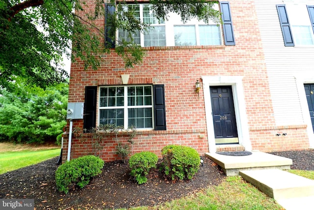 doorway to property with brick siding